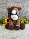 Photo of our brown crocheted horse with blue reins