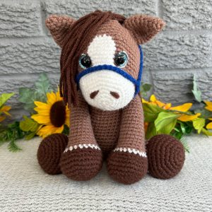 Photo of our brown crocheted horse with blue reins