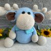 photo of crocheted moose, with a blue body and bright blue bow