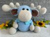 photo of crocheted moose, with a blue body and bright blue bow