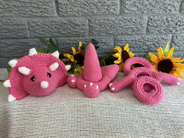 photo of Bright pink crocheted dinosaur ring stacking toy