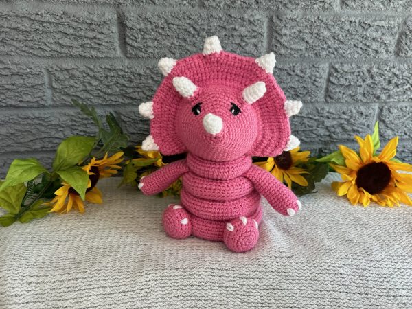 photo of Bright pink crocheted dinosaur ring stacking toy