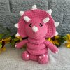 photo of Bright pink crocheted dinosaur ring stacking toy