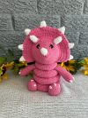 photo of Bright pink crocheted dinosaur ring stacking toy