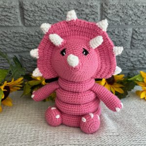 photo of Bright pink crocheted dinosaur ring stacking toy