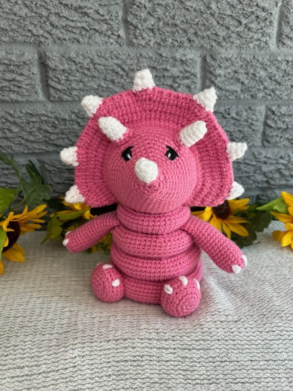 photo of Bright pink crocheted dinosaur ring stacking toy