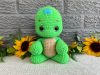 Photo of our crocheted stuffed turtle in bright green with a brown shell