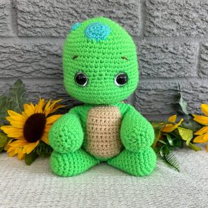 Photo of our crocheted stuffed turtle in bright green with a brown shell