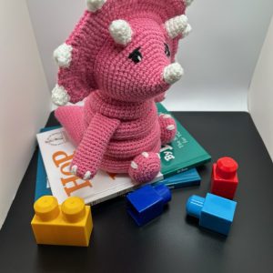 crochet-baby-ring-toy-pink-jj2.jpg Side view of handmade crocheted dinosaur stacking ring toy