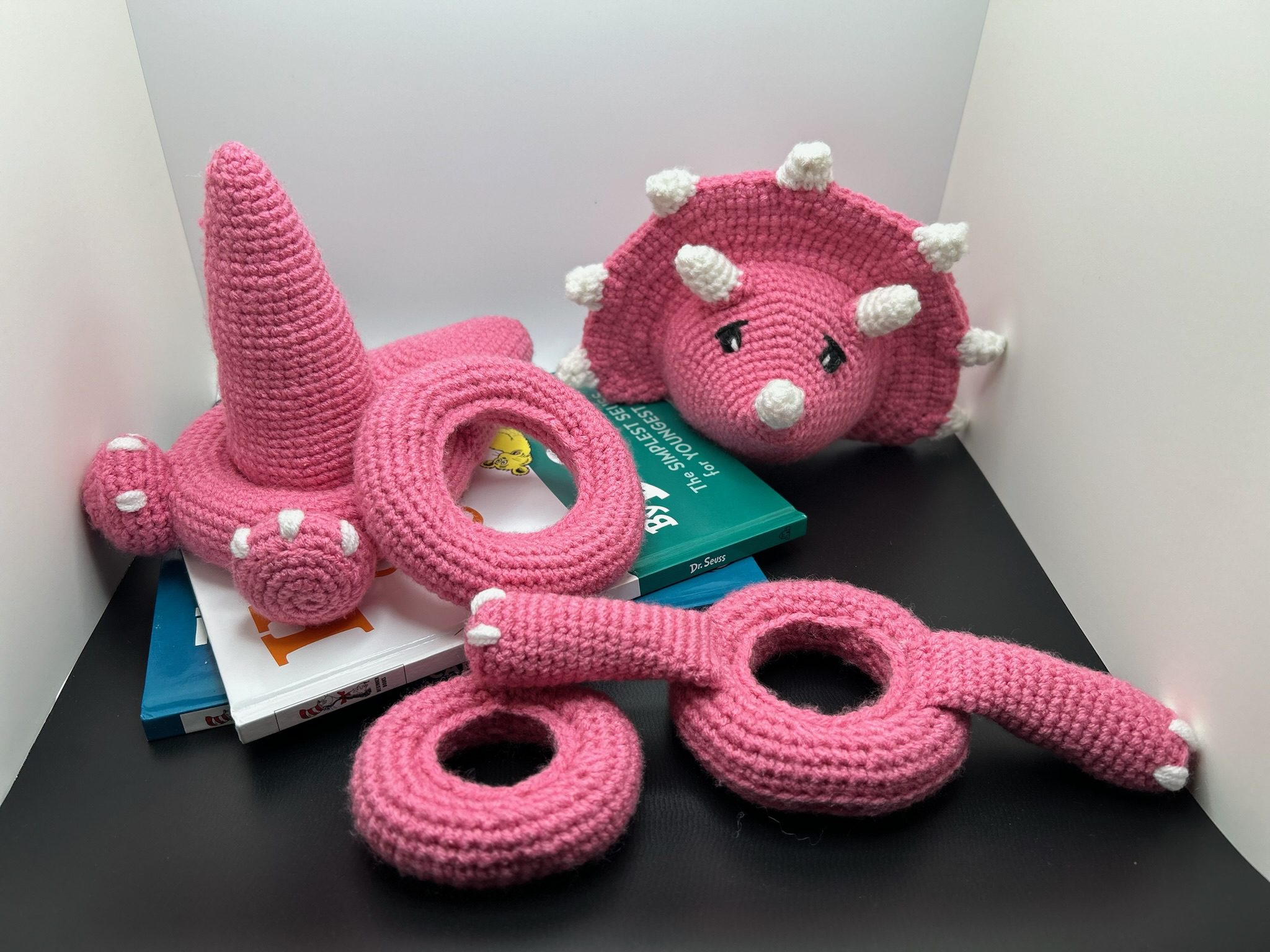 Second view of disassembled handmade crocheted dinosaur stacking ring toy