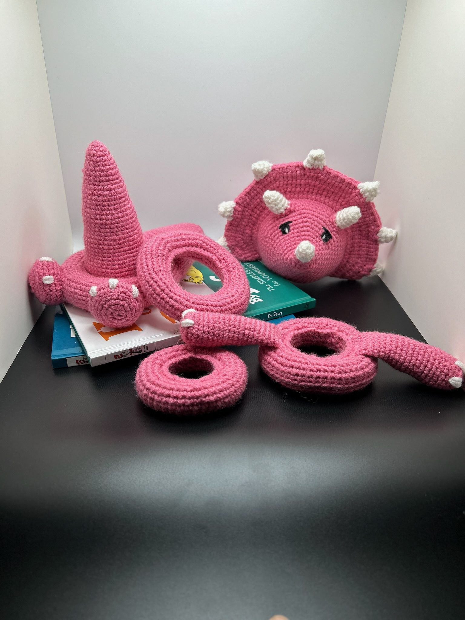 Second view of disassembled handmade crocheted dinosaur stacking ring toy