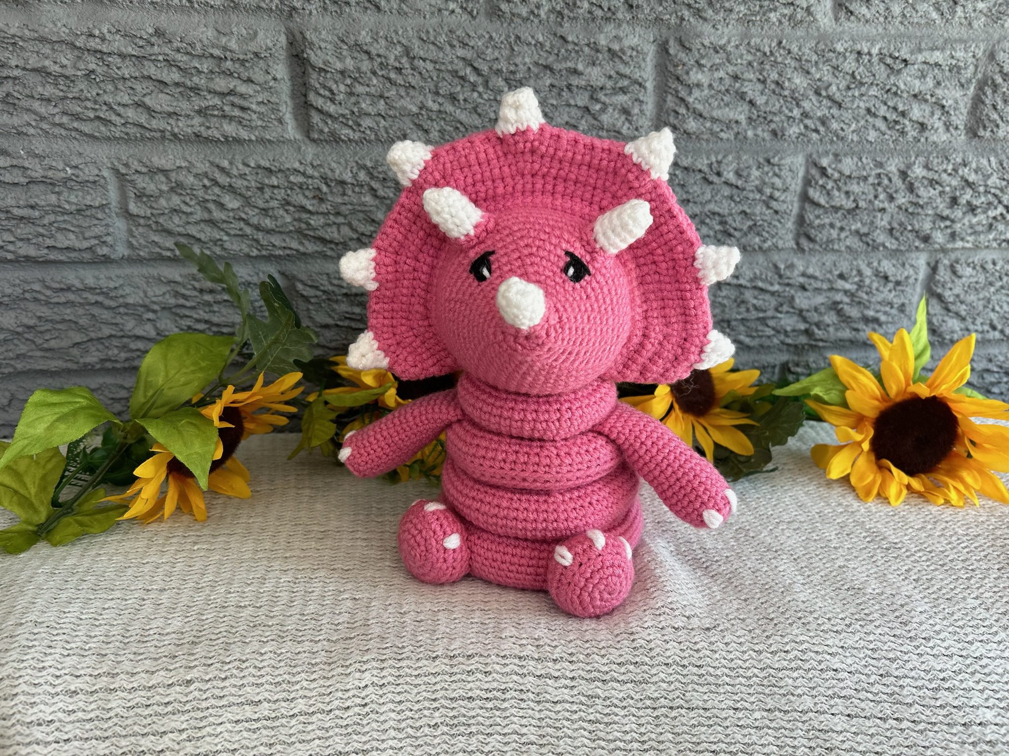 Handmade crocheted dinosaur stacking ring toy