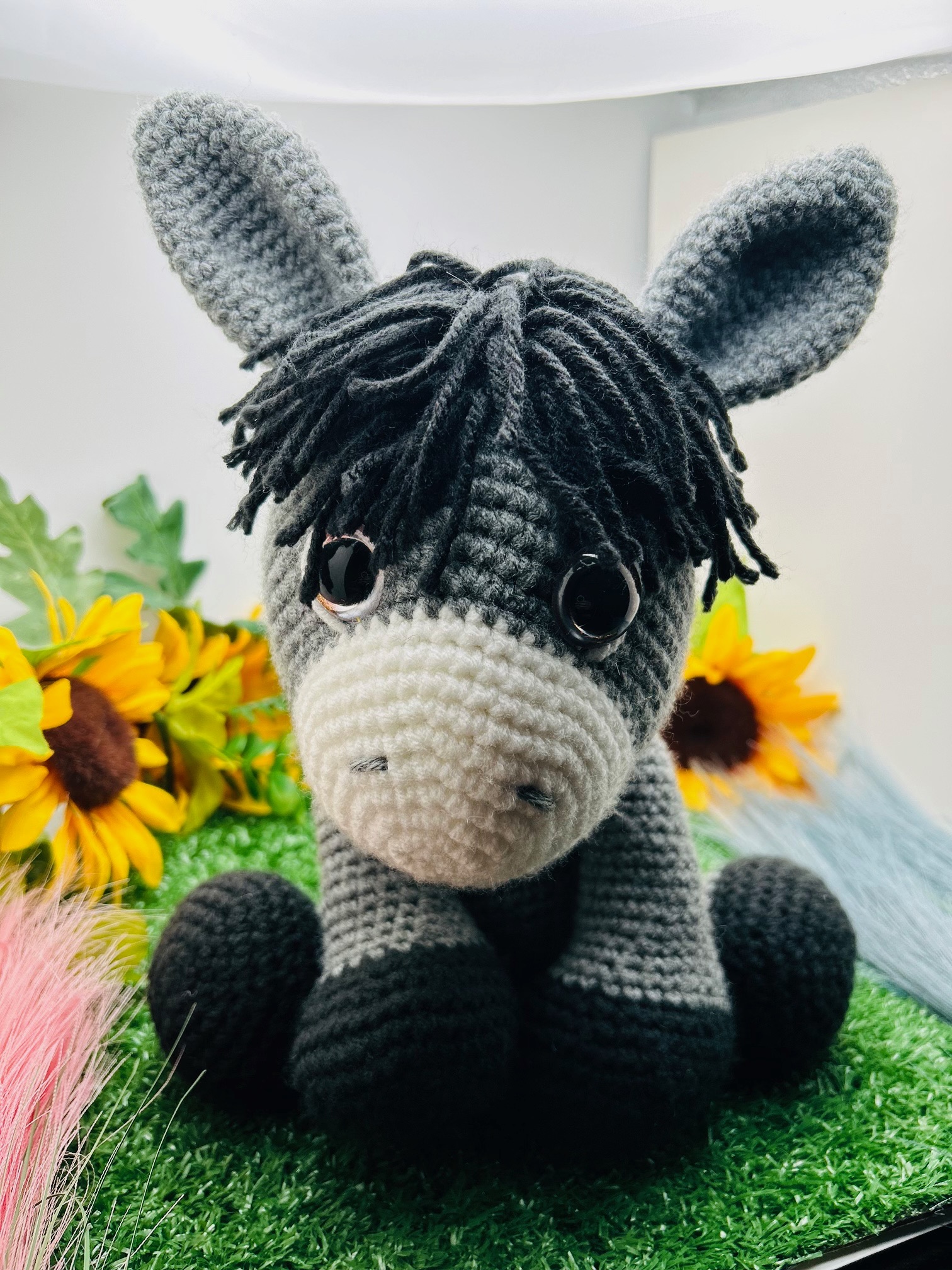Close-up of handmade crocheted stuffed donkey