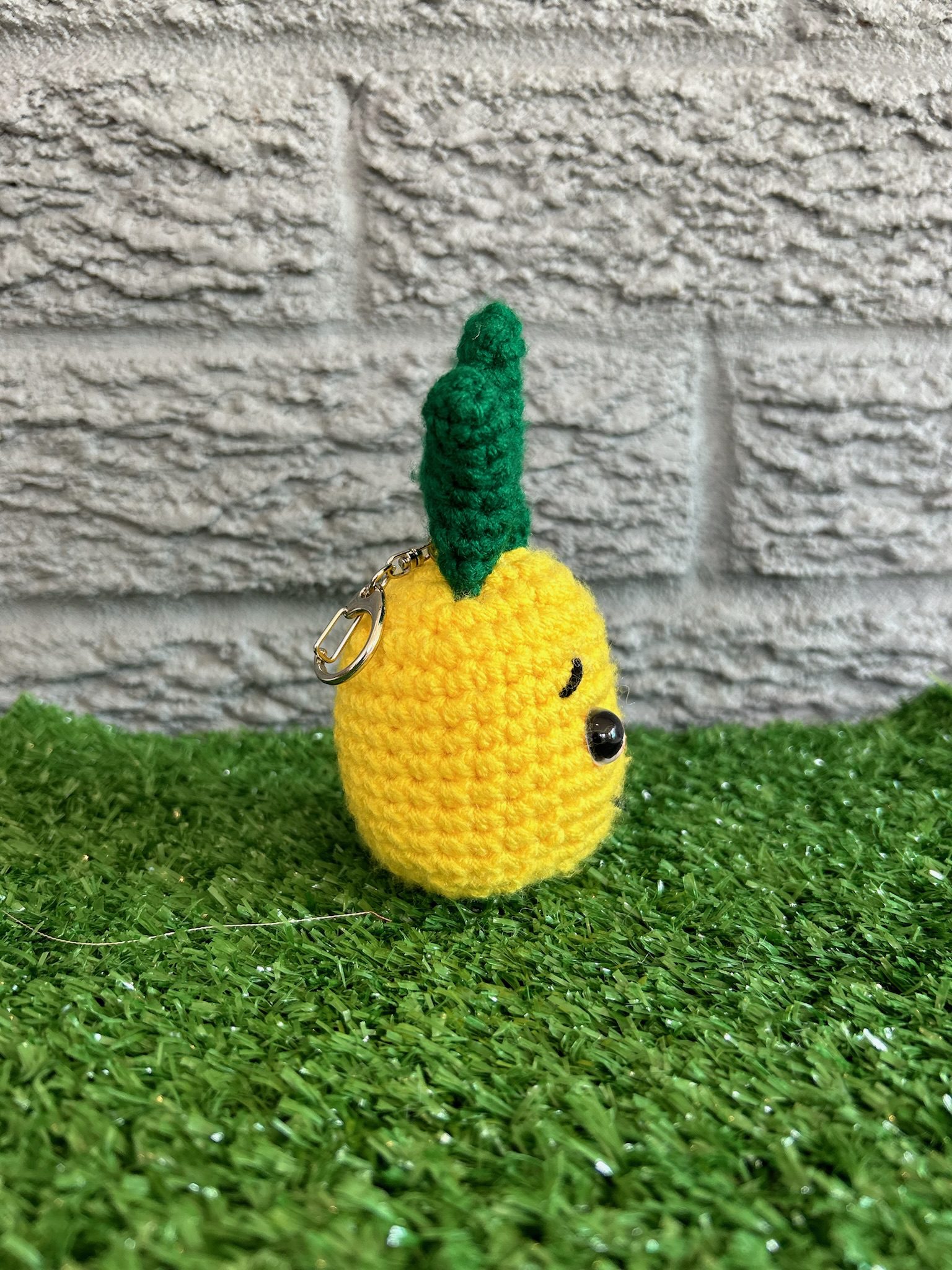 Side view of handmade crochet pineapple keychain