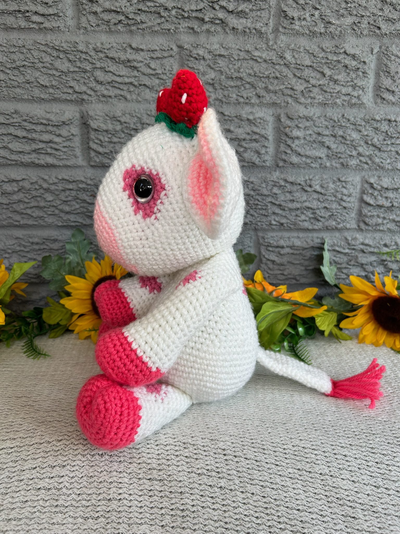 Side view of handmade crocheted strawberry cow
