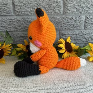 Side view of handmade crocheted stuffed fox