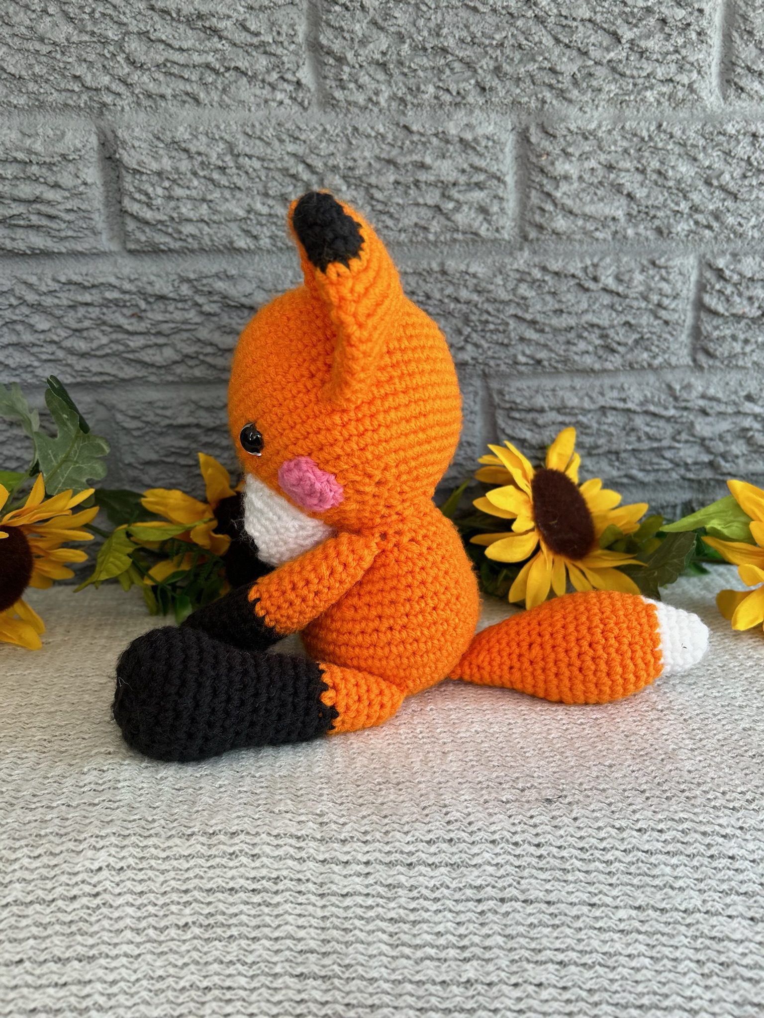 Side view of handmade crocheted stuffed fox