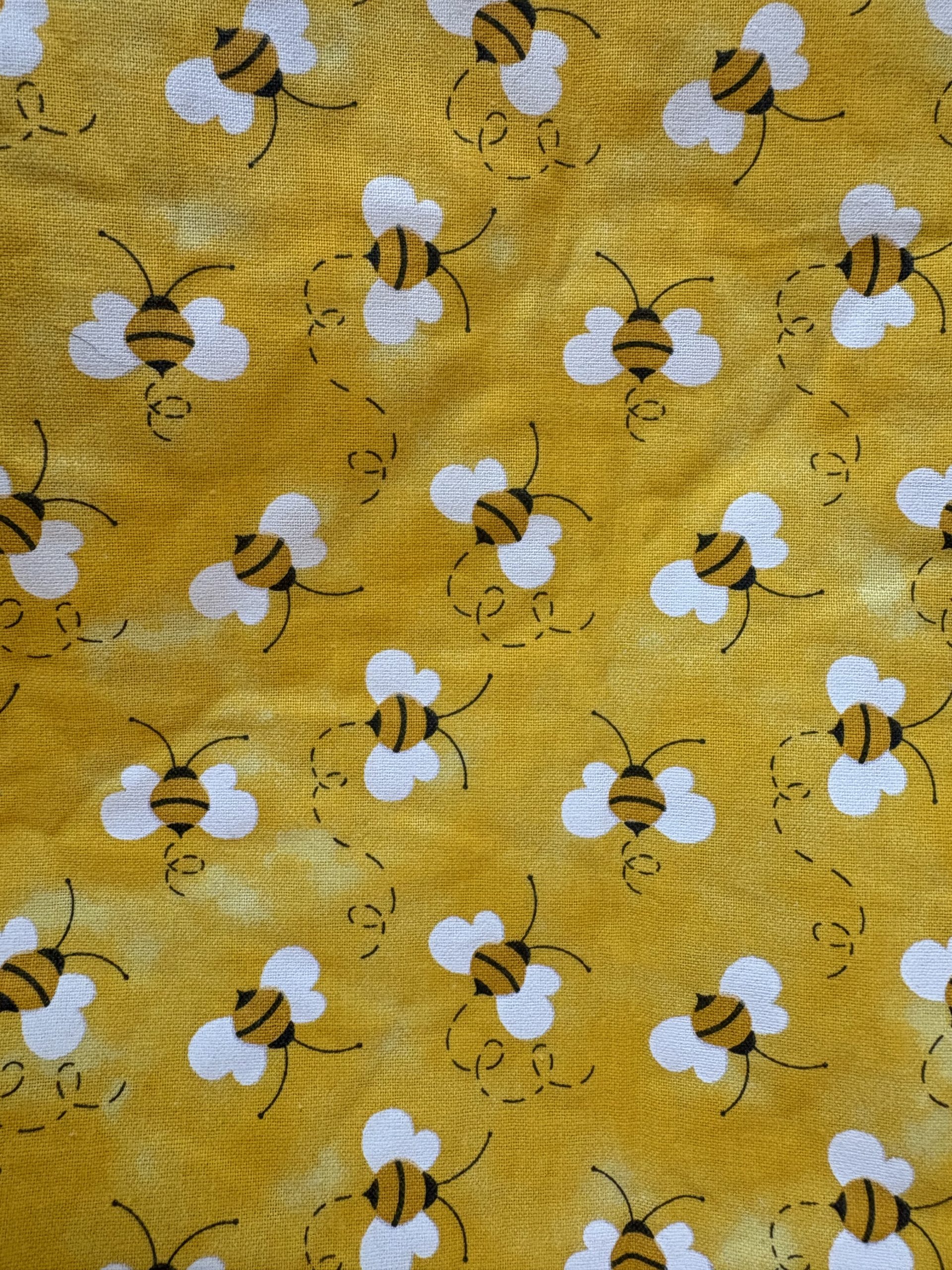 Close-up of handmade bee print zipper pouch
