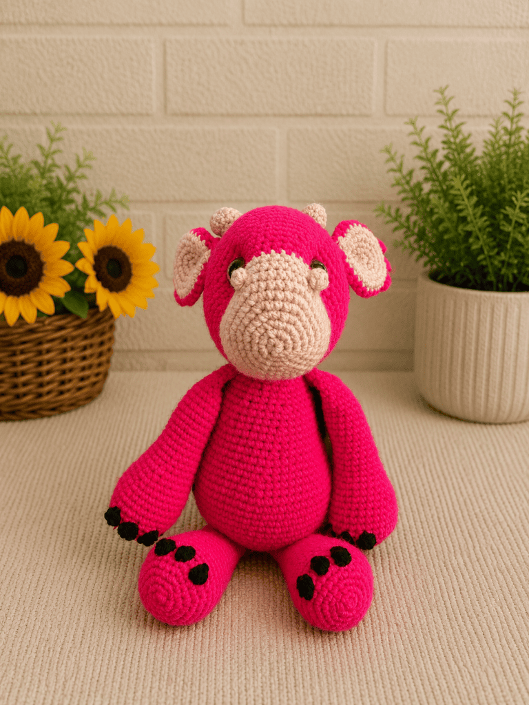 Handmade crochet pink dragon plush sitting upright