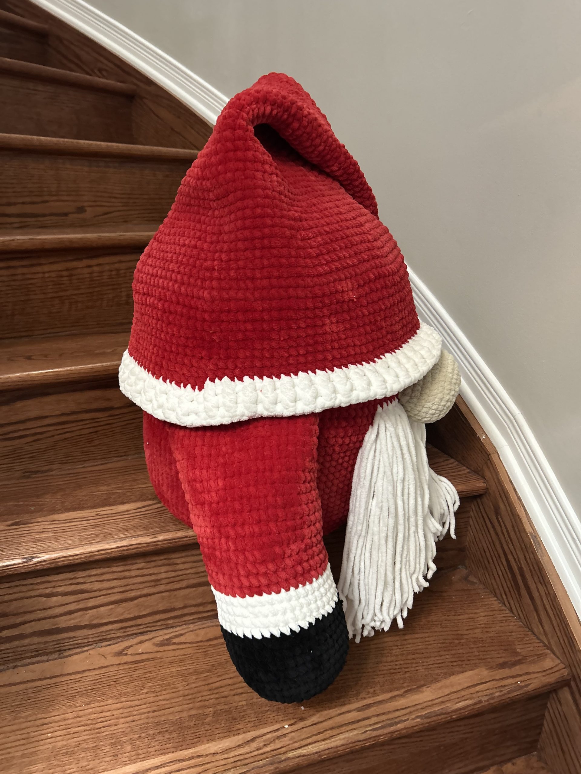 Side view of giant handmade crocheted santa gnome